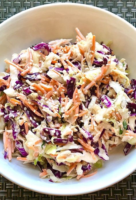 Creamy Sesame Coleslaw is my go-to slaw with all of the crunchy textures from the cabbage and carrots, the slight bite from the scallions, the creaminess from the mayonaise. and the nutty flavor from the Sesame Oil and Seeds. It really is a sidekick that can go with anything. http://talkingmeals.com/sesame-coleslaw/ #coleslaw #coleslawrecipes #easyrecipes #easydinners #weeknightdinners #simplerecipes #dinner Sesame Coleslaw, Asian Coleslaw Recipe, Cabbage And Carrots, Asian Coleslaw, Amanda Nicole, Asian Slaw, Nicole Smith, Asian Salad, Slaw Recipes