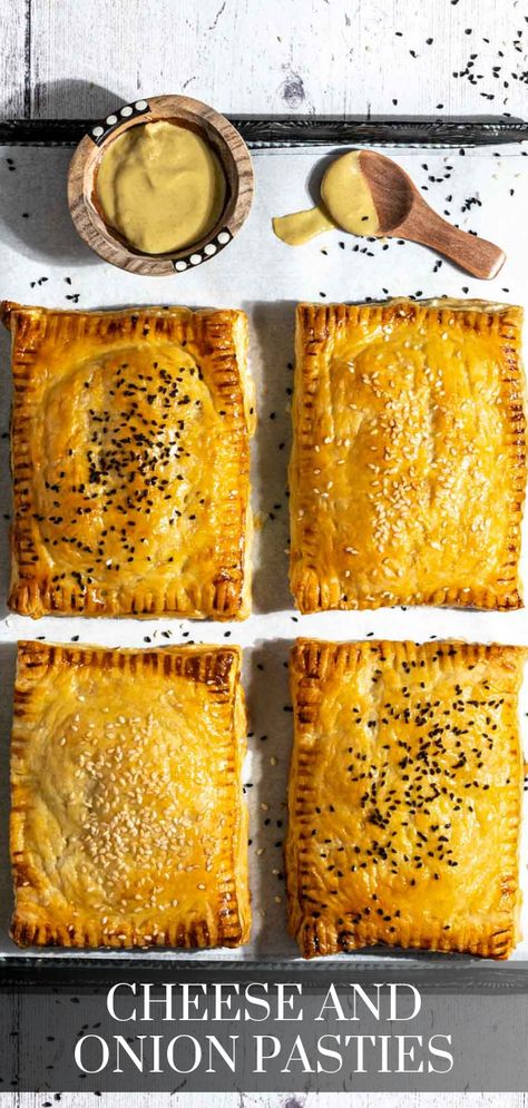 Four cheese and onion pasties on a baking sheet with a small bowl of mustard. Cheese And Onion Pasty, Puff Pastry Shells, Chicken Puffs, Caramelised Onion, Potato Cheese, British Dishes, Nigella Seeds, Easy Cheese, British Baking