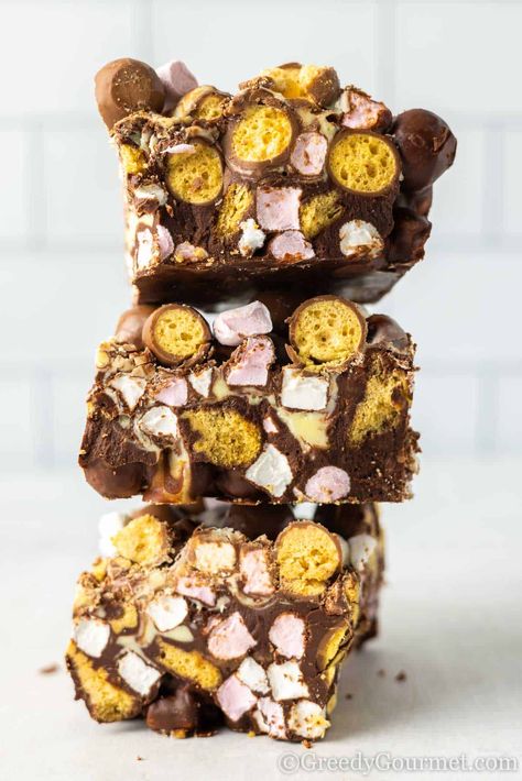 stack of malteser rocky road pieces. Deconstructed Rocky Road Bars, Malteser Rocky Road, Easter Rocky Road, Malteser Tray Bake, Malted Milk Biscuits, Marshmallow Rocky Road, School Baking, Rocky Road Candy, Rocky Road Bars