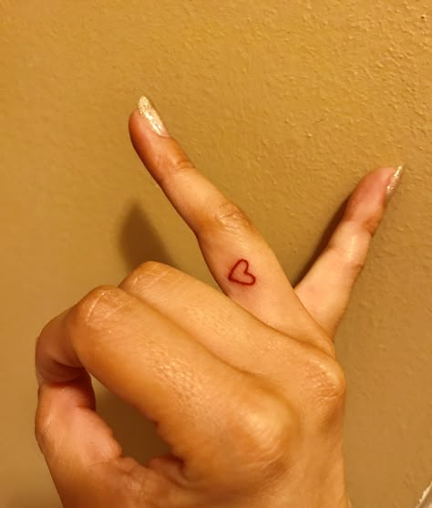 Red heart finger tattoo ♥️ Small Tattoos Heart Finger, Small Red Finger Tattoo, Red Tattoo On Wrist, Heart On Thumb Tattoo, Tattoo Heart Finger, Red Heart Hand Tattoo, Red Tattoo Finger, Red Ink Finger Tattoo, Tiny Heart Tattoo Finger