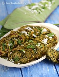 Patra, fame is not easily earned, and if this recipe is so popular, it must be because it combines those rare qualities of flavour and good health! colcocasia leaves are very nutritious as well as tasty, especially if made into patra – a smooth paste of besan with spicy, sweet and sour flavours is applied over the leaves, rolled and steamed. This requires skill and practice; however, it is easy once you start doing it. You can also make mini patras by using small leaves to make small rolls. ... Patra Recipe, Fried Snacks, Gujarati Cuisine, Indian Appetizers, Small Leaves, Gujarati Food, Deep Fry, Gujarati Recipes, Evening Snacks