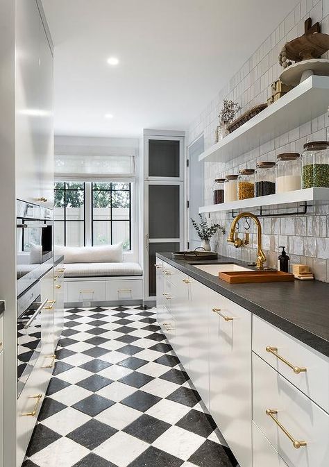 Black and white harlequin floor tiles accent a galley style kitchen pantry boasting white flat front cabinets adorned with brass pulls and a black leathered marble countertop. French Transitional Home, Harlequin Floors, French Transitional, Brooke Wagner Design, Brooke Wagner, French Oak Flooring, Dream Interior, Butler’s Pantry, Beautiful Kitchen Designs