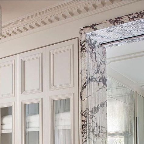 Elizabeth Bolognino on Instagram: "An exquisite display of details— from the fluted marbling on the door frames, floor to ceiling antique mirrors, elegant ceiling moulding, to the beautiful millwork on the built-in storage between the bedroom and the bathroom. 

Interior design by @estudiomariasantos" Marble Doorway, Marble Mirror, London Residence, Classic Hotel, Marble Frame, Marble Showers, Door Design Interior, Marble Decor, Interiors Magazine