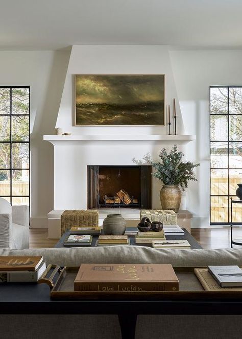 A Samsung Frame TV hangs over a white plaster fireplace mantel finished with a hearth and flanked by tall windows. White Plaster Fireplace, Tudor Fireplace, Tudor Renovation, Plaster Fireplace, Tv Over Fireplace, Windsor House, Living Tv, Tall Windows, Living Room Renovation