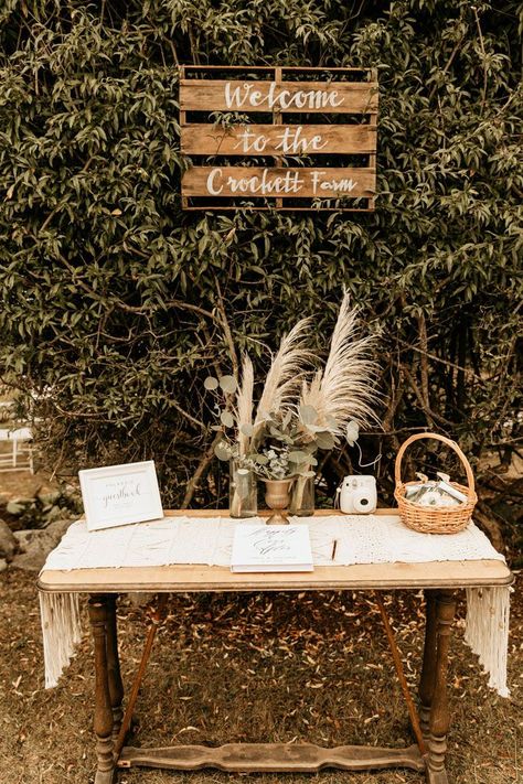 This rustic + boho welcome table features pampas grass and greenery floral pieces | Image by Maya Lora Photo Boho Wedding Signing Table, Boho Guestbook Table, Boho Card Table Wedding, Boho Wedding Guest Book Table, Boho Guest Table Wedding, Rustic Wedding Entry Table, Boho Guest Book Table, Boho Welcome Table, Boho Memory Table Wedding