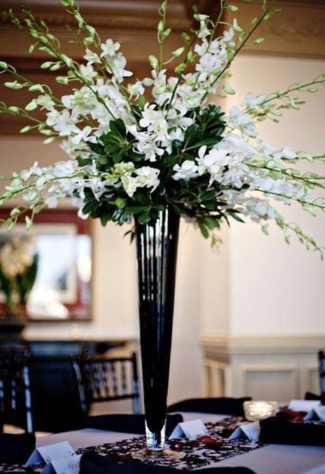 A simple but elegant vase, our tall black glass trumpet vase is an excellent choice for any gathering. It is the perfect vase for floral displays and wedding centerpieces. Tapered from the top all the way down to its strong footed base allows for support of large and heavy floral arrangements. Tall Vase Wedding Centerpieces, Trumpet Vase Centerpiece, Cheap Wedding Table Centerpieces, Orchid Centerpieces, Tall Wedding Centerpieces, Easy Wedding, Unique Wedding Flowers, Wedding Floral Centerpieces, Tall Centerpieces