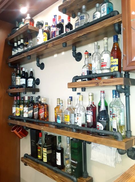 Pipe Bar Shelves Industrial Bar Shelving, Behind Bar Shelving Ideas, Basement Bar Shelves Ideas, Diy Bar Wall Shelves, Industrial Liquor Shelves, Bar Shelf Display, Bar Bottle Display Shelving, Rustic Bar Shelves Ideas, Whiskey Glass Display