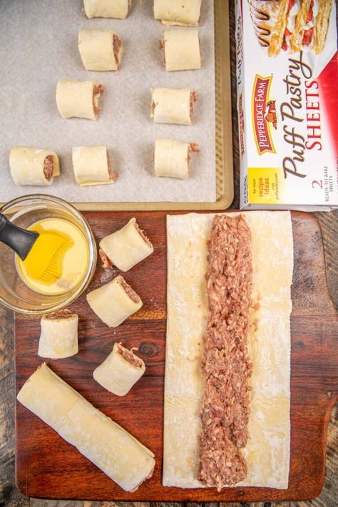 Puff Pastry Sausage Rolls - super simple to make and packed full of great flavor! Puff pastry dough stuffed with ground pork sausage and baked until golden brown. Super simple to make and they taste great! Serve with your favorite dipping sauce. Can make in advance and freeze them for a quick treat later. Perfect for parties, breakfast, an afternoon snack, and game day! Puff Pastry Sausage Pinwheels, Sausage Cups, Sausage Rolls Puff Pastry, Puff Pastry Sausage Rolls, Breakfast Puff Pastry, Sausage Pinwheels, Sausage Puffs, Puff Pastry Recipes Savory, Pastry Puff