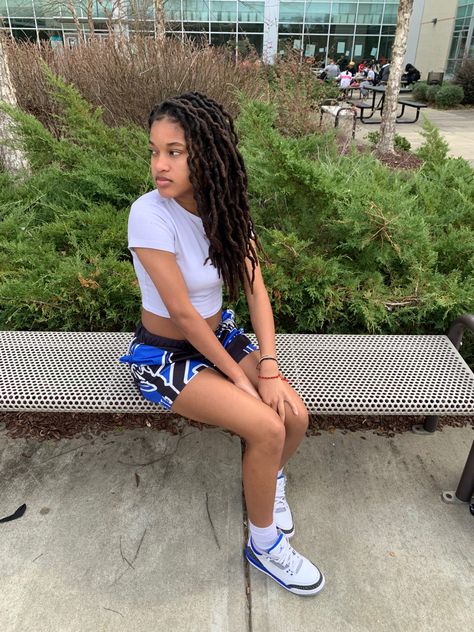 a girl wearing a white crop top with blue and white basketball shorts and blue jordan 3s Jordans Outfit Womens Summer, Jordan 3 Outfit Women, Shorts Outfits Summer, Jordan 3 Outfit, Outfits Summer 2022, Jordan Outfits Womens, Jordan 3s, Jordan Fits, Graphic Shorts