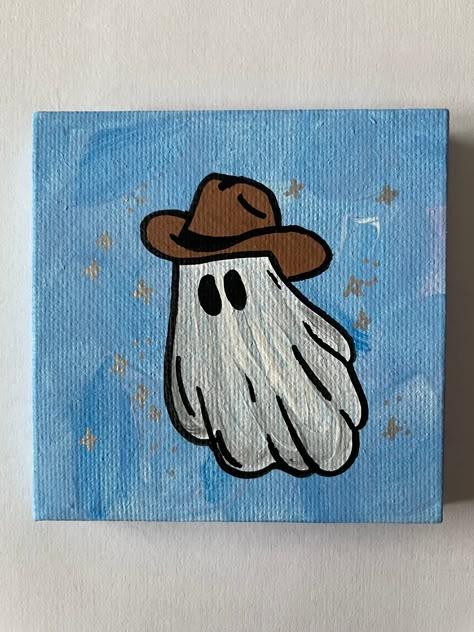 "3\"x3\" Blue Hand Painted Sparkle Halloween Ghost with Cowboy Hat Canvas Painting This small ghost painting is the perfect addition to your fall/Halloween decor.  Hand painted on a 3\"x3\" canvas with acrylic paint, each painting is one of a kind.  A great gift for a friend or family member or perfect just for you!" Mini Halloween Paintings, Ghost With Cowboy Hat, Ghost Paintings, Ghost Halloween Decor, Halloween Canvas Paintings, Western Ghost, Art Mini Toile, Halloween Canvas Art, Cute Easy Paintings