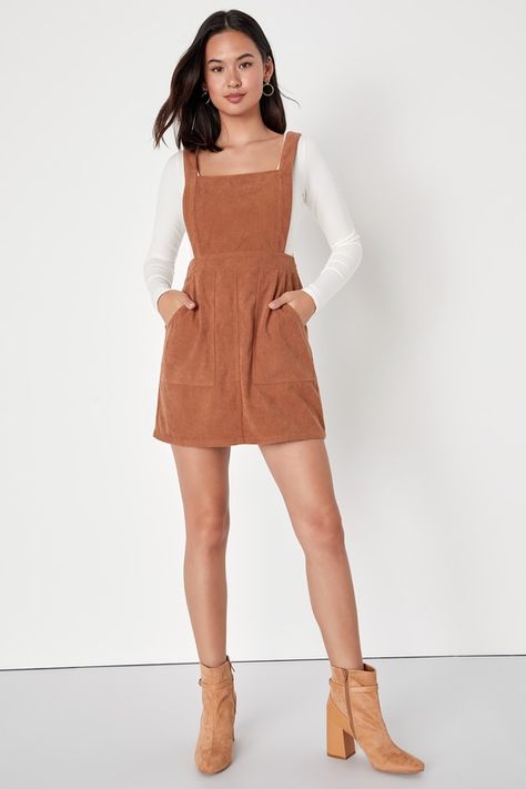 The Lulus Embracing Autumn Brown Corduroy Pinafore Mini Dress is the overall winner for the cutest look this season! This trendy pinafore dress has a velvety corduroy composition that shapes an apron-style bodice, a square neckline, and wide straps. A banded waist tops a figure-skimming mini skirt with front porkchop pockets. Exposed silver back zipper. Layer with a mock neck top for a retro 'fit! Fit: This garment fits true to size. Length: Mid-thigh. Size medium measures 32.5" from shoulder to Winter Corduroy Brown Dress, Casual Corduroy Pinafore Dress For Fall, Spring Mini Corduroy Dresses, Corduroy Dress Outfit, Tan Corduroy Overall Dress, Overall Dress Outfit, Mini-length Corduroy Dresses For Spring, Melbourne Winter, Trendy Outfits Boho