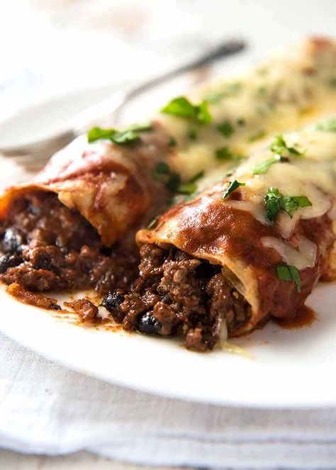 Close up of Beef and Bean Enchiladas on a plate, ready to be eaten Beef Enchilada, Beef Enchiladas With Refried Beans, Beef And Bean Enchiladas, Beef Bean Enchiladas, Paleo Beef Enchiladas, Beef And Black Bean Enchiladas, Enchiladas Beef Authentic, Beef N Bean Enchiladas, Authentic Enchiladas Beef