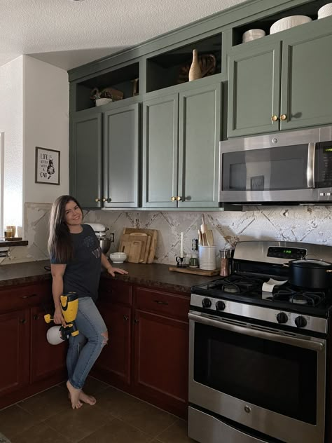 I Painted My Kitchen Cabinets Green! Painted Kitchen Cabinets Before And After Green, Half Wood Half Painted Cabinets, Green Brown Kitchen Cabinets, Olive Green Cabinet Colors, Green Base Kitchen Cabinets, Painted Upper Kitchen Cabinets, Kitchen Cabinet Color With Black Countertops, Dark Green Cabinets Black Hardware, Cherry Cabinets Green Island