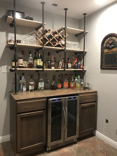 Gas pipe shelves over rustic bar Diy Bar Shelf Ideas, Diy Bar Shelves, Wall Bar Ideas, Bar Shelf Ideas, Basement Bar Design, Basement Bar Ideas, Modern Home Bar, Bar Sala, Basement Bar Designs