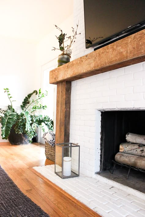 Eclectic Minimalism in Park City (Part 1) | Shining on Design Wood Framed Fireplace Surround, White Fireplace Brick With Wood Mantel, Fireplace With Natural Wood Mantel, Wood Beam Fireplace Surround, White Tile Fireplace Wood Mantle, Wood Frame Around Fireplace, Love Edge Fireplace Mantle, Stone Fireplace Without Mantle, Modern Southwest Fireplace