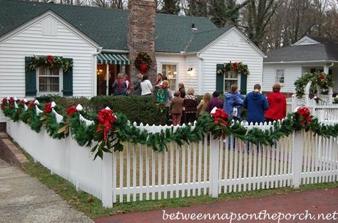 Christmas Decorating Ideas for Porches, Doors and Windows Christmas Garland Fence Ideas, Christmas Decor Fence Ideas, White Picket Fence Christmas Decor, Christmas Lights Fence Ideas, Christmas Garland Outdoor Fence, Picket Fence Christmas Ideas, How To Decorate A Fence For Christmas, Decorating A Fence For Christmas, Garland On Fence Christmas