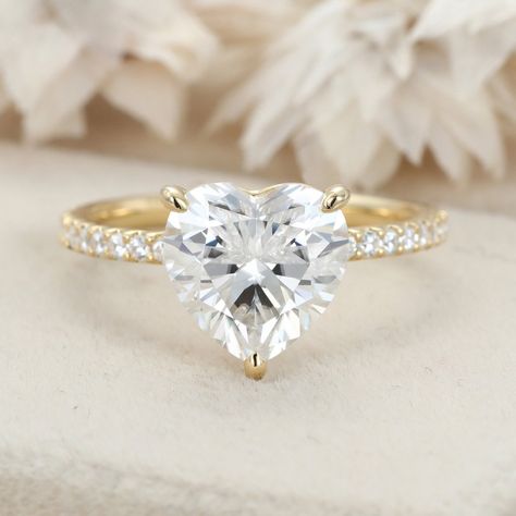 Indulge in captivating brilliance with our Pave Set Side-Stone 3 Carat Heart Cut Moissanite Engagement Ring, elegantly crafted in 14K Yellow Gold. This stunning piece captures the essence of eternal love, promising a lifetime of happiness and romance. Heart Diamond Engagement Ring, Heart Cut Engagement Ring, Cute Promise Rings, Heart Shaped Diamond Ring, Heart Shaped Engagement Rings, Radiant Cut Rings, Heart Engagement Rings, Diamond Heart Ring, Gold Diamond Engagement Rings