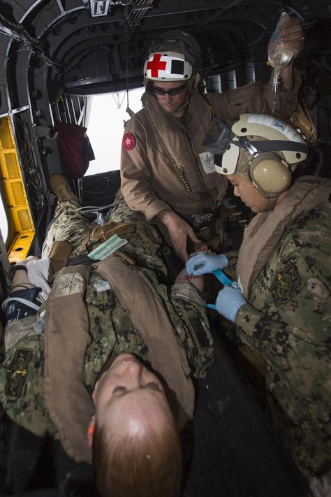 U.S. Navy Lt. J.G. Jennifer Tran, right, Expeditionary Resuscitative Surgical System (ERSS) Team 12 critical care nurse and native of Fairfax, Va., and Hospital Corpsman Chief Jonathan Tarkowski, Marine Medium Tiltrotor Squadron (VMM) 263 (Reinforced), 22nd Marine Expeditionary Unit (MEU), medical chief and native of Tulsa, Okla., treat a simulated patient aboard a CH-53E Super Stallion during a tactical evacuation drill. The 22nd MEU is deployed with the Bataan Amphibious Ready Group as a t... Us Navy Corpsman, Navy Nurse Corps, Hospital Corpsman, Navy Hospital Corpsman, Critical Care Nurse, Navy Corpsman, Marine Officer, Navy Life, Critical Care Nursing