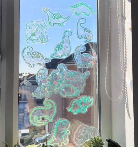 Adorable dinosaur window decals that create rainbows across your walls when hit with direct sunlight 🌈 Rainbow Window Sticker, Goblin Decor, Dino Bathroom, Uni House, Rainbow Window, Pinterest Contest, Suncatcher Window, Hologram Stickers, Silly Things