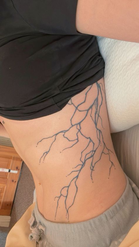 Lightning Tattoo Side Rib, Lightning Side Tattoo, Lightning Tattoo Stomach, Lightning Tattoo Women Ribs, Struck By Lightning Tattoo, Lighting Strikes Tattoo, Lightning Rib Tattoo, Lighting Arm Tattoo, Lightnight Bolt Tattoo