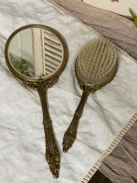 Vintage Victorian hand mirror measuring 13 1/2" x 5" x 1/2". The hairbrush measures 10" x 3 1/4" x 1 1/2".   This is a used antique set of a vanity, hairbrush, and mirror that need a good cleaning.  Many of the pieces in my shop are pre-loved and vintage. Some may have imperfections that are a part of the pieces history. I will put these imperfections in the description. Please look over the pictures and feel free to ask any questions before purchasing.  Thank You ! No return policy Vintage Vanity Set, Antique Hairbrush, Victorian Hand Mirror, Vintage Hand Held Mirror, Vintage Glam Decor, Vintage Hairbrush, Vegas Aesthetic, Vintage Hand Mirror, Vintage Trinkets