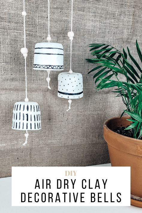 Hanging decorative clay bells in white and black Air Dry Clay Bells Diy, Clay Bells Diy, Air Dry Clay Projects For Adults, Air Dry Clay Wind Chimes, Air Dry Clay Home Decor, Air Dry Clay Decor, Ceramic Altar, Clay Bells, Clay Home Decor