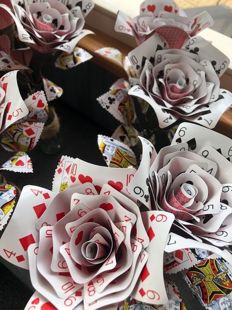 How To Make A Rose Out Of Playing Cards, How To Make Roses Out Of Playing Cards, Playing Cards Flowers, Playing Cards Alice In Wonderland, Card Game Decorations, Playing Card Decoration Ideas, Deck Of Cards Crafts, Playing Card Decorations, Designer Themed Party