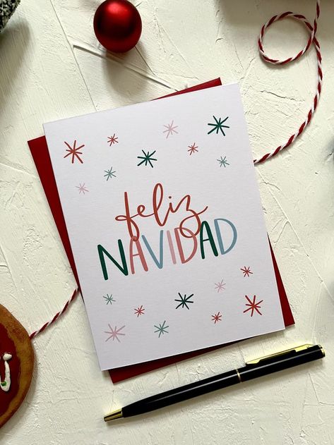 4.25"x5.5" card with red hand lettered "feliz" and green, blue and red block letter "navidad" with red and green hand drawn stars Christmas Card Calligraphy, Christmas Hand Lettering, Spanish Christmas Cards, Diy Christmas Cards Easy, Pretty Envelopes, Hand Lettering Envelopes, Hand Lettered Christmas, Spanish Christmas, Christmas Calligraphy