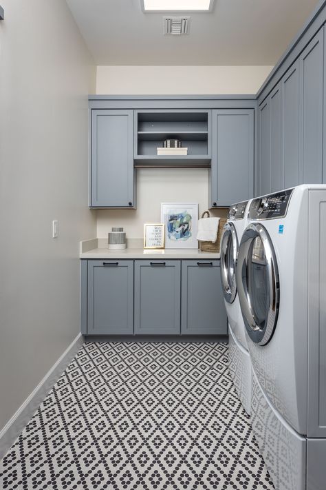 The laundry room, though often overlooked, is a space where our garments and linens are transformed from dirt and grime to freshness and comfort. This small laundry room design features powder blue as its main color palette, providing a calm and serene atmosphere for efficiently carrying out those house chores we don't love to do! Black And Blue Laundry Room, Grey And Blue Laundry Room, Laundry Room Design Blue, Baby Blue Laundry Room, Laundry Room Cabinet Colors, Navy Blue Laundry Room, Blue Laundry Room Cabinets, Laundry Room Colors Scheme, Small Laundry Room Design Ideas