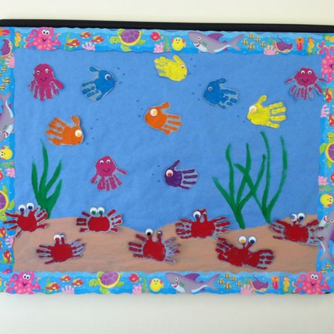 Under Water Bulletin Board Ideas, Beach Display Board Nursery, Under The Sea Eyfs Display, Under The Sea Preschool Decorations, Hand Print Bulletin Board Ideas, Under The Sea Board Ideas, Ocean Board Preschool, Under The Sea Door Decorations, Under The Sea Door Decorations Classroom