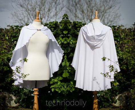 ~ White Druid Capelet ~ Made to Measure ~  Made using seductively soft and stretchy 100% cotton jersey material, with wibbley thread detail in white and a pretty antique gold clasp. The White Druid Capelet is a simple and beautiful design that is very versatile. It would be a perfect for a Handfasting or Wedding for either the Bride to be or the Bridesmaids <3 It's also a perfect addition every White Witches wardrobe. ~ Each order is lovingly made by me for you ~ ~ Together we celebrate the Goddess within ~ All of the designs in my collection are original & unique. I work very hard to create designs that break away from the mainstream. I work in a very happy environment with herbal teas on tap, surround by wonderful materials, an extensive music collection and a lovely view of a fabric mil White Fantasy Costume Accessories For Cosplay, White Fantasy Cosplay Costume, White Cloak Aesthetic, White Hooded Cloak, White Cloak With Hood, Bohemian White Shawl Cape, White Cloak, White Cape, Wedding Cape