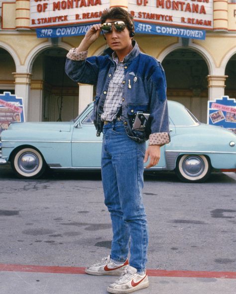 Michael J. Fox’s signature look in the movie “Back to the future,” 1985. He wore denim-on-denim with a pop of plaid, a pair of Nike’s and… Marty Mcfly Costume, Dark Academia Aesthetic Fashion, Chicago Outfit, 80s Denim, Michael J Fox, J Fox, Denim Jacket Outfit, Sneakers Fashion Outfits, Marty Mcfly