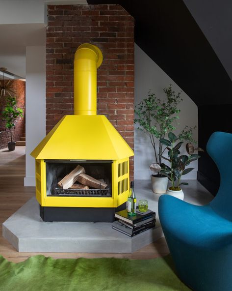 A yellow fireplace sits in a living room with a bright teal chair in the corner and decorations all around. Victorian Aesthetics, Post Modern, Small Living, Postmodernism, Creative Director, New Life, Pittsburgh, York City, New York City