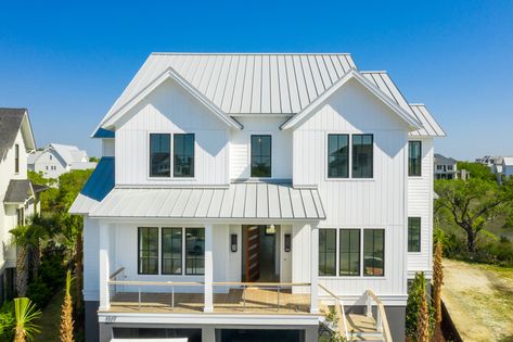 This white home is right on the coast of Daniel Island and Charleston, SC. It's interior and extorior both display a modern look. It is also covered by a dove grey metal roof. Beach House Metal Roof, White House White Roof, White House With Metal Roof, White House Gray Roof, White House Metal Roof, Light Metal Roof, White Roof House, Light Gray Roof, Grey Metal Roof