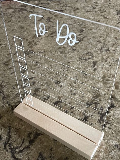 "This listing is for a clear acrylic dry erase to do list. Cut from 1/8\" clear acrylic. Words and lines are engraved on the backside for easy cleaning! Measures 7\" wide x 8 3/4\" tall with rounded corners. Available with or without wooden stand - see drop down menu. Looking for a custom acrylic sign? Message us for custom orders and pricing." Hanging Acrylic Sign On Wall, Acrylic Signs With Cricut, Laser Engrave On Acrylic, Acrylic To Do List Board, Acrylic To Do Board, Circuit Acrylic Projects, Circut Projects Ideas To Sell, Cricut Dry Erase Vinyl Ideas, Cricut Acrylic Signs