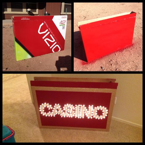 Homemade Light Up Casino Sign Step 1: Find a large TV box. Step 2: spray paint the box. Step 3: frame the box with glitter tape. Step 4: glue on white card stock letters. Step 5:  poke Christmas lights through cardboard around the letters Casino Sign, Casino Party Games, Las Vegas Party, Glitter Tape, Casino Logo, Vegas Night, Casino Party Decorations, Casino Decorations, Poker Party