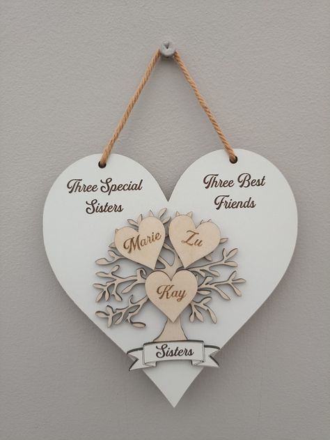 Wall hanging wooden heart and family tree sister ornament, three special sisters, three best friends. Lovely sentimental gift for a special sister which can be personalised with your name and your beloved sisters name. Please provide three names to be engraved in the hearts on the tree instead of love and family. This ornament is made from 3mm white faced MDF and 3mm plywood. This ornament is available in 2 sizes: Standard: 150mm x 150mm Large: 200mm x 200mm Sister Decor, Sister Ornament, Sister Sign, Birthday Gift For Sister, Three Best Friends, Personalised Family Tree, Sister Sister, Sisters By Heart, Handmade Wall Hanging