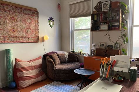 Corner of home multipurpose space with office, desk area, brown comfy chair, orange filing cabinet, pillows, blue striped area rug, yoga equipment Architecture Desk, Railroad Apartment, Multipurpose Space, Film Dance, Pillows Blue, Striped Area Rug, Desk Area, Rental Apartment, Apartment Rental