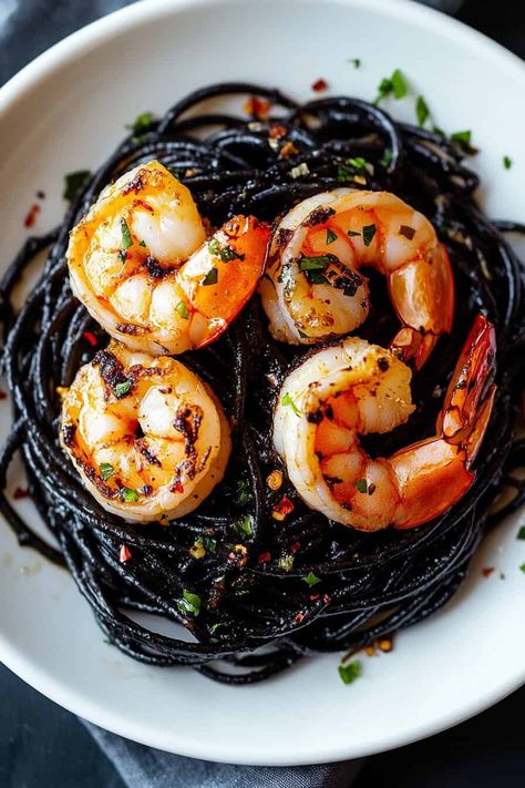 Looking for a Halloween dinner idea? This Vampire Pasta made with squid ink pasta, garlic, and shrimp is the ultimate spooky meal! The dark, mysterious noodles and savory shrimp create a hauntingly good dish that will thrill your guests. Add this festive recipe to your Halloween menu and serve up something eerie yet delicious! Black Pasta With Shrimp, Black Pasta Halloween, Vampire Pasta, Vampire Recipes, Beet Risotto, Black Pasta, Pasta Garlic, Ink Pasta, Pasta With Garlic