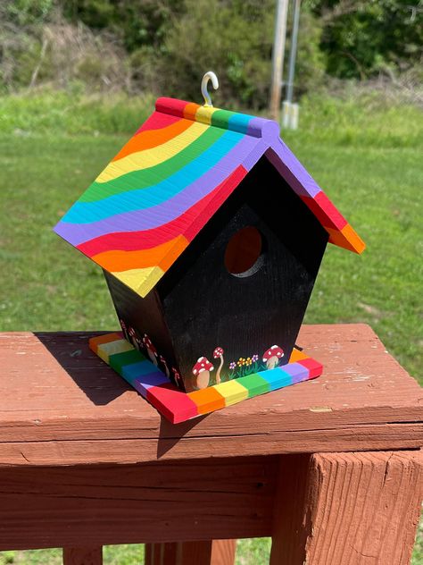 This is a wood painted birdhouse, featuring cute mini mushrooms and bright rainbow colors Bird House Decorations, Colorful Bird Houses, Rainbow Birdhouse, Creative Bird Houses, Bird Feeder Painting Ideas, Mini Birdhouse Painting Ideas, Bird House Ideas Painted, Painted Bird Houses Ideas Diy, Hand Painted Birdhouses Ideas