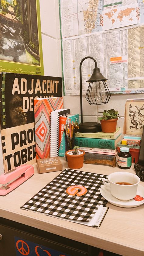 Checkered folder, corner of office with rich colors, eclectic Knick nacks and a lamp. Grandmillenial Maximalist, Pink Stapler, Cubicle Decor Office Work Spaces, Eclectic Office Decor, Boho Cubicle Decor, Maximalist Office, Cozy Cubicle, Maximalist Vintage, Colorful Books