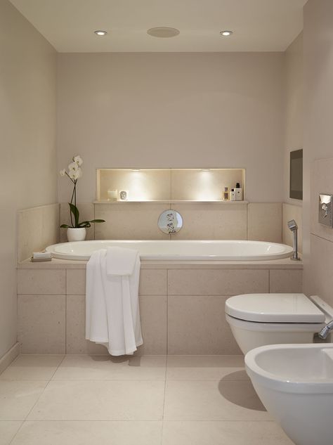 The alcove bathtub features a TV screen integrated into the wall and ceiling mounted audio. Wall mounted sanitary ware gives the visual of 'lightness'. #bathrooms #ensuite #bathtub #tiles Tub Alcove Ideas, Bath In Alcove, Ensuite Bathtub, Integrated Bathtub, Bathroom Alcove, Bathtub Tiles, Country House Bathroom, Unclog Bathtub Drain, Cloak Room