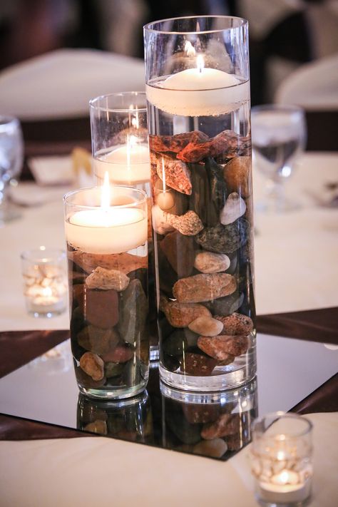 Vases With Rocks Centerpiece Ideas, Rocks And Candles Centerpiece, Rocks Wedding Decor, River Rock Wedding Decor, River Rock Decorating Ideas, Rock Wedding Centerpieces, Stone Wedding Centerpieces, River Rock Centerpiece, Masculine Party Centerpieces