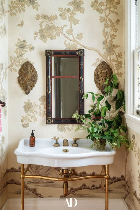 A sweet bathroom area blooms anew thanks to a leafy wallpaper. #bathrooms #bathroomideas #bathroominspo #guestbathrooms #wallpaper #greenery #windows #design #colonial #gold Colonial Revival House, Tree Grows In Brooklyn, Autumn Interior, Wallpaper Bathroom, Glass Garage Door, Scenic Wallpaper, Prospect Park, Rooms Reveal, Park Homes