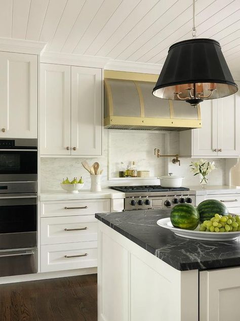 Well appointed white and gold kitchen features a black drum light pendant hung from a shiplap ceiling above a white center island contrasted with a honed black marble countertop. House Seven Design, White And Gold Kitchen, Black Marble Countertops, Marble Kitchen Counters, Kitchen Design Countertops, Marble Kitchen Island, White Marble Kitchen, Marble House, Marble Countertops Kitchen