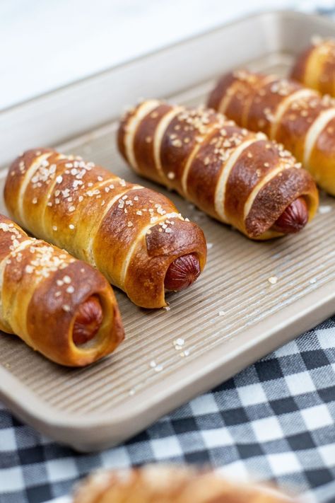 These homemade Pretzel Dogs are absolutely delicious! With the perfect combination of a chewy soft pretzel and a juicy hot dog, they make a great lunch, dinner or party food that’s sure to be a hit with kids and adults alike. Pretzel Hot Dogs, Homemade Pretzel Dogs, Pretzel Dogs Recipe, Homemade Pretzel, Pretzel Dogs, Wrapped Hot Dogs, Soft Pretzel Recipe, Homemade Pretzels, Salty Treats