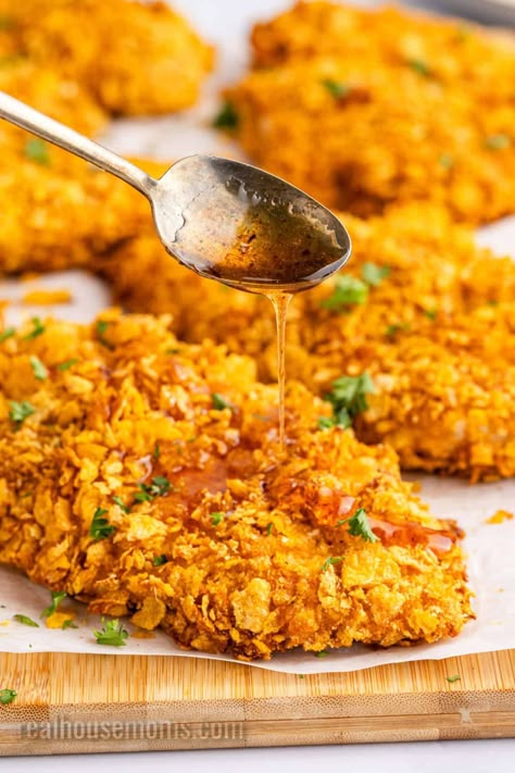 Crunchy on the outside, tender and juicy on the inside, this Hot Honey Cornflake Chicken recipe is a deliciously easy weeknight dinner! #Realhousemoms #hothoney #cornflakes #chicken #cornflakechicken #chickenrecipe #comfortfood #easydinner #backtoschool #kidapproved Honey Cornflake Chicken, Crunchy Honey Chicken, Cornflake Chicken Breast, Corn Flake Chicken Tenders, Cornflakes Chicken, Cornflake Chicken Tenders, Corn Flake Chicken, Red Hot Chicken, Cornflake Recipes