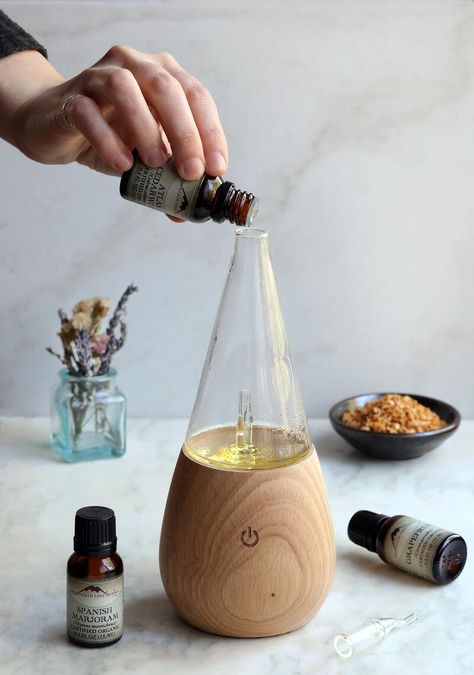 Hand pouring drops of essential oil into diffuser to make spanish marjoram aroma diffuser blend Breathe Diffuser Blend, Waterless Diffuser, Marjoram Essential Oil, Tea Drops, Essential Oils Herbs, Diffuser Sticks, Essential Oil Diffuser Recipes, Oil Diffuser Recipes, Room Diffuser