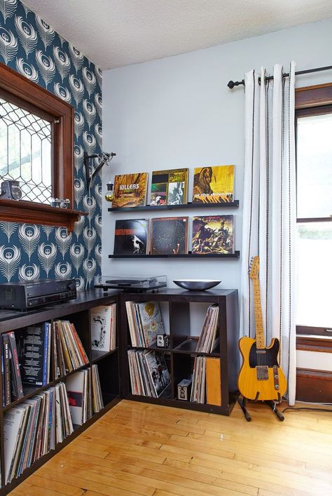 Include plenty of storage to keep your music room organized and looking polished. Use open cubbies or shelves to stash vinyl records, music books, sheet music, and more. Simple metal stands are great for storing and displaying instruments when not in use. #musicroom #musicroomideas #homedecor #bhg Small Music Room, Basement Music Room, Office Music Room, Music Room Art, Music Room Design, Music Room Ideas, Home Music Rooms, Music Corner, Vinyl Room