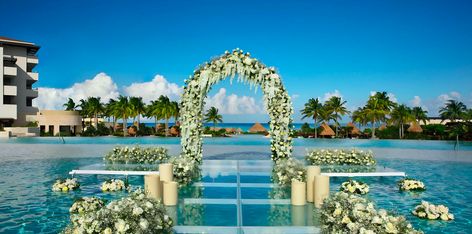 Saying "I do" while standing over a beautiful pool at Dreams Playa Mujeres Weddings.  Learn more about it at the link to this pin. Infinity Pool Wedding, Dreams Playa Mujeres Wedding, Weddings Under 5000, Tropical Honeymoon, Unique Destination Wedding, Dreams Resorts, Pool Wedding, Cancun Wedding, Authentic Wedding